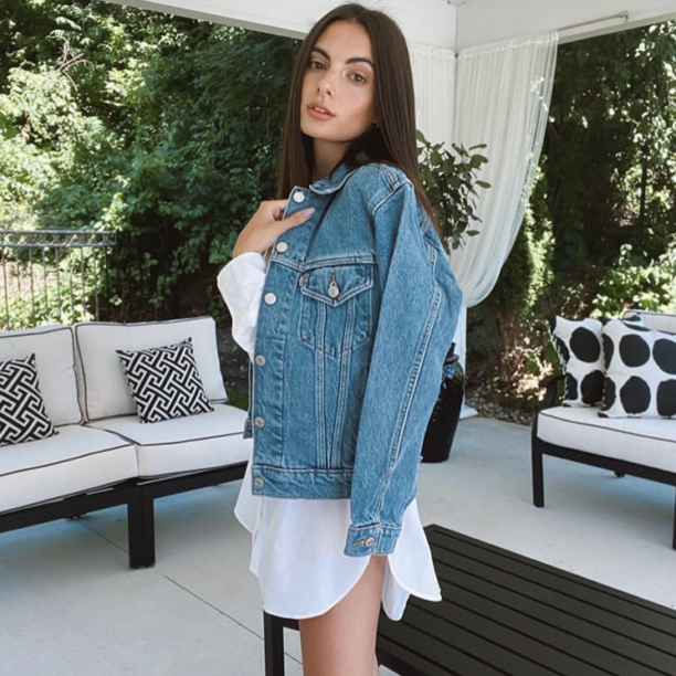 Young woman with long hair wearing a denim jacket and jeans Stock Photo -  Alamy